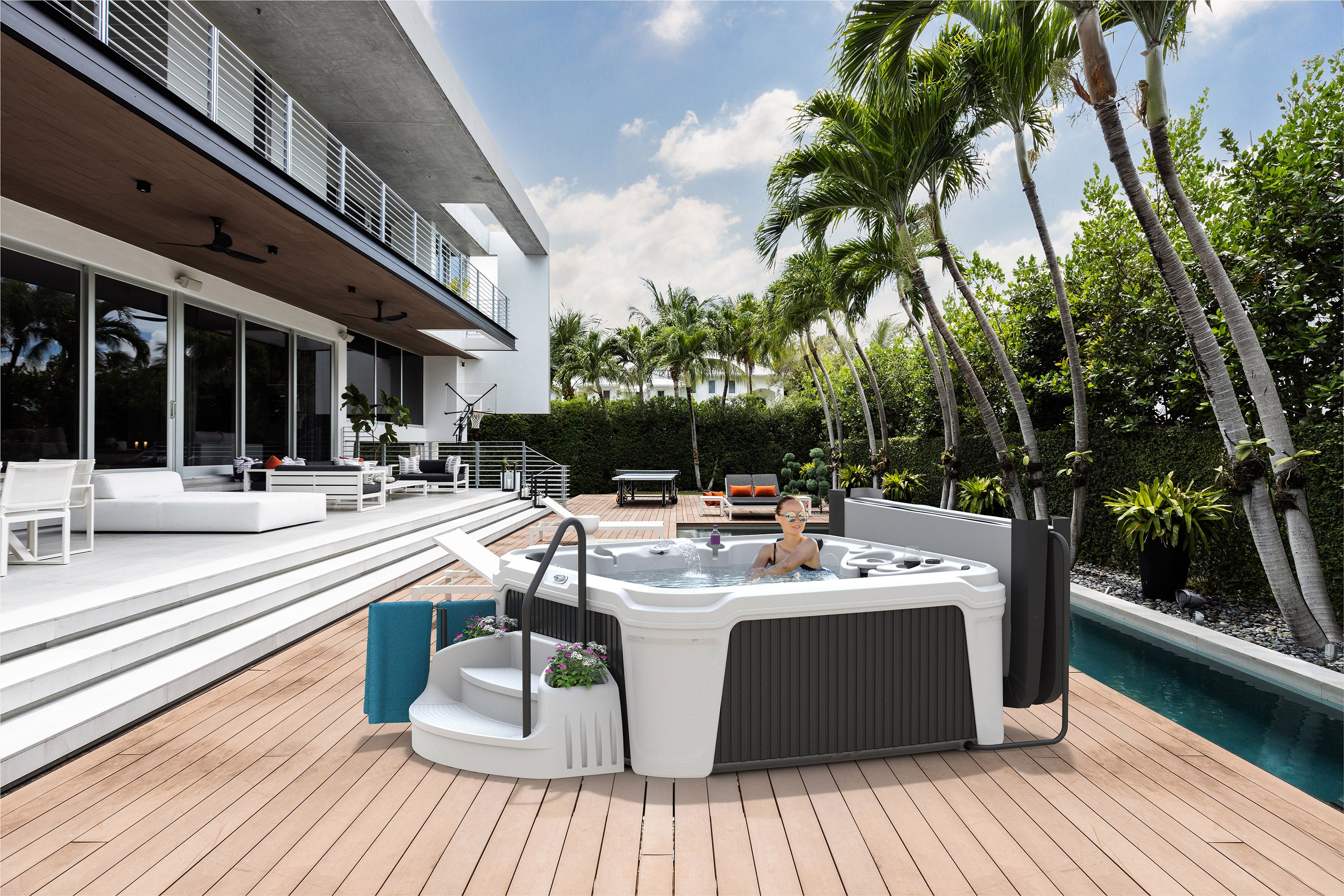 An AquaRest Spas Daydream 3500S Hot Tub sits on a deck in a backyard